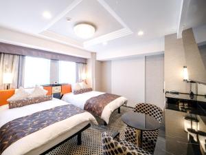 a hotel room with two beds and a table at APA Hotel AkihabaraSuehirocho Ekimae -Electric Town- in Tokyo