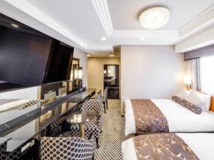 a hotel room with two beds and a flat screen tv at APA Hotel AkihabaraSuehirocho Ekimae -Electric Town- in Tokyo