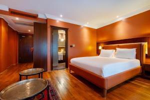 A bed or beds in a room at Mangana Konak Hotel