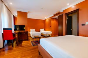 A bed or beds in a room at Mangana Konak Hotel