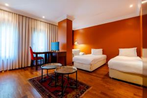 A bed or beds in a room at Mangana Konak Hotel