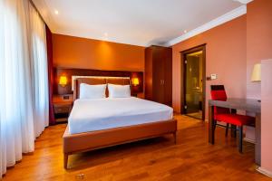 A bed or beds in a room at Mangana Konak Hotel