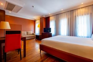 A bed or beds in a room at Mangana Konak Hotel
