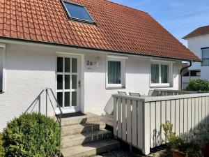 a white house with a staircase and a red roof at Haus Alkmene in Bodman-Ludwigshafen +6 photos