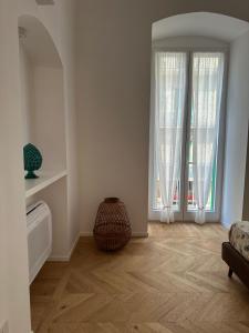 a living room with wooden floors and large windows at Bellapulia apartments in Molfetta +27 photos