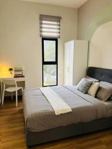 a bedroom with a bed with a desk and a window at The Cove Hillside Ipoh by Iconique in Tambun +64 photos