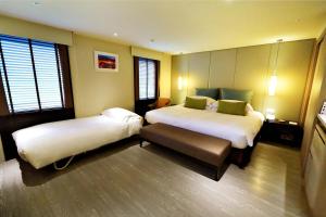 Postel nebo postele na pokoji v ubytování The Gaia Hotel - Taipei