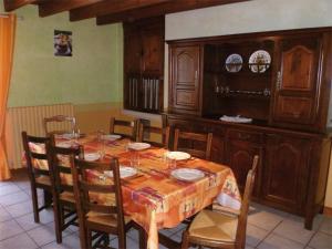 a dining room with a wooden table and chairs at Franmélie in Valence en Poitoux