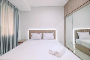 Ένα ή περισσότερα κρεβάτια σε δωμάτιο στο Relaxing Studio at Daan Mogot City Apartment By Travelio +10 φωτογραφίες