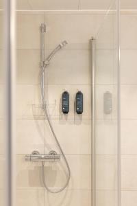 a shower in a bathroom with a glass door at Stay North Paradis in Stavanger +36 photos