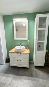 a bathroom with a white sink and a mirror at Juaniz in Tolmin +23 photos