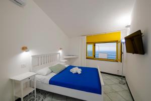 Кровать или кровати в номере Terrazza sul mare