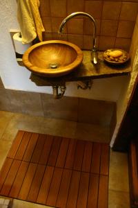 a bathroom with a wooden sink on a counter at Guesthouse KaraIvan in Arda