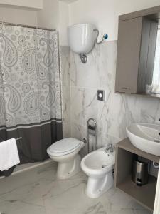Un baño con inodoro, lavabo y ducha. en Acrita rooftop, en Zambrone