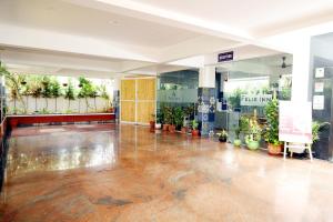 a lobby of a building with potted plants at Felix Inn - Manyata Tech Park in Bangalore