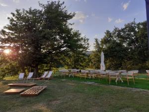a group of tables and chairs under a tree at Golf Resort de Digne-les-Bains by Adonis in Digne-les-Bains