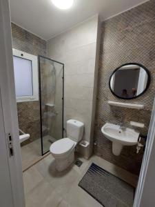 a bathroom with a toilet and a sink and a mirror at Villa Mountain View North Coast ماونتن فيو رأس الحكمه in Ras Elhekma +7 photos