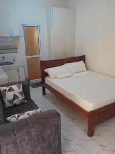 a living room with a bed and a couch at Aphyl Homes B2 in Mombasa