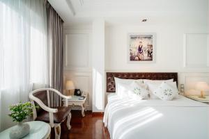 Postel nebo postele na pokoji v ubytování Alagon Saigon Hotel & Spa