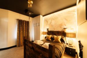 a bedroom with a wooden bed with a marble wall at Casa Amor - Adult Only Jacuzzi Suite in Southampton