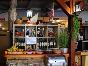 a shelf filled with bottles of wine in a store at Visovac Rooms in Skradin
