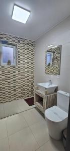 a bathroom with a toilet and a sink at Merci Apartament 1,0 in Sibiu +25 photos