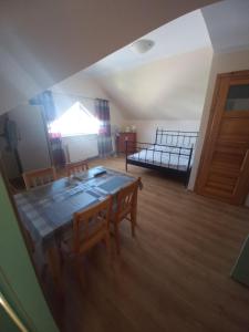 a room with a table and two beds in it at Robi pokoje i apartament in Łeba