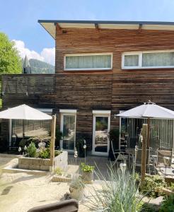 a house with two umbrellas in front of it at Chalet Maya in Schladming