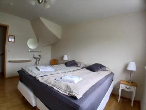 a bedroom with a bed with two towels on it at Guesthouse Tálknafjörður in Talknafjordur +7 photos