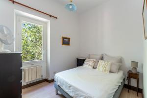 a bedroom with a white bed and a window at Maison de maitre domaine Beauchamp in Grans +24 photos