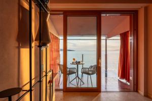 a living room with a view of the ocean at Laqua by the Sea in Meta