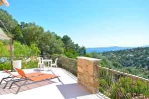 a patio with a table and chairs on a balcony at Provenzalisches Haus La Grenouille - Terrasse mit Meerblick und privatem Pool by Riviera HomeLife in Les Issambres