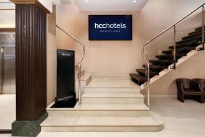a staircase in a building with a sign on the wall at HCC Regente in Barcelona +80 photos