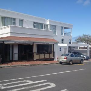 a white building with a car parked in front of it at Heaven@Hermanus in Hermanus