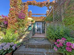 a garden with flowers on a building with a patio at Sant'Anna Del Volterraio - Papaveri 7 in SantʼAnna +41 photos