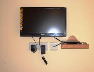 Elle comprend une télévision à écran plat suspendue au mur. dans l'établissement Pokhrel Lodge, à Kalimpong