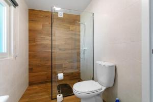 a bathroom with a toilet and a glass shower at Casa do Canudo in Marinha Grande +21 photos