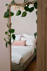 a room with a couch with a plant on it at Hyem at Cullercoats in Cullercoats