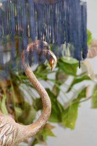 a bird with a long tail in a vase at Hyem at Cullercoats in Cullercoats