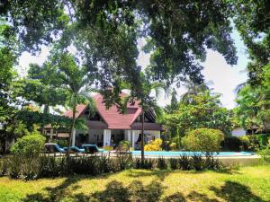 a house with a swimming pool in a yard at Nyumba Malaika in Malindi