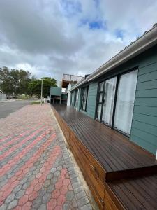 a wooden deck on the side of a building at Hartenbos Vakansie in Mossel Bay