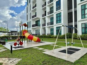 a playground in front of a building with a slide at Jk Yarra Park Resort Style 8Pax 3BedR2BathR in Kuching