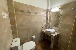 a bathroom with a toilet and a sink at Mariannis Studios in Skala