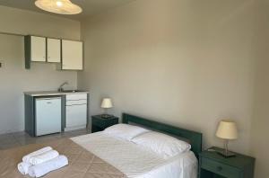 a bedroom with a bed with two towels on it at Mariannis Studios in Skala