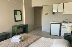 a bedroom with a bed with towels on it at Mariannis Studios in Skala