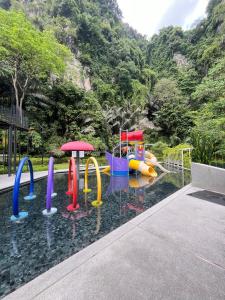 a pool with a water park with a playground at The Cove Hillside Ipoh by Iconique in Tambun