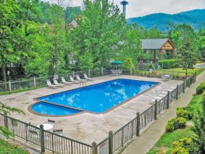 a swimming pool with chairs and a fence around it at River Terrace Resort & Convention Center in Gatlinburg