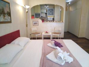a bedroom with a large white bed with towels on it at Lea Beo in Belgrade