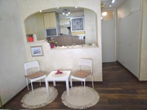 a room with two chairs and a table and a mirror at Lea Beo in Belgrade