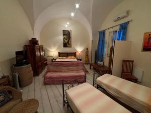 a room with two beds and a tv in it at Il Castello te Lu Sannà in Merine +91 photos